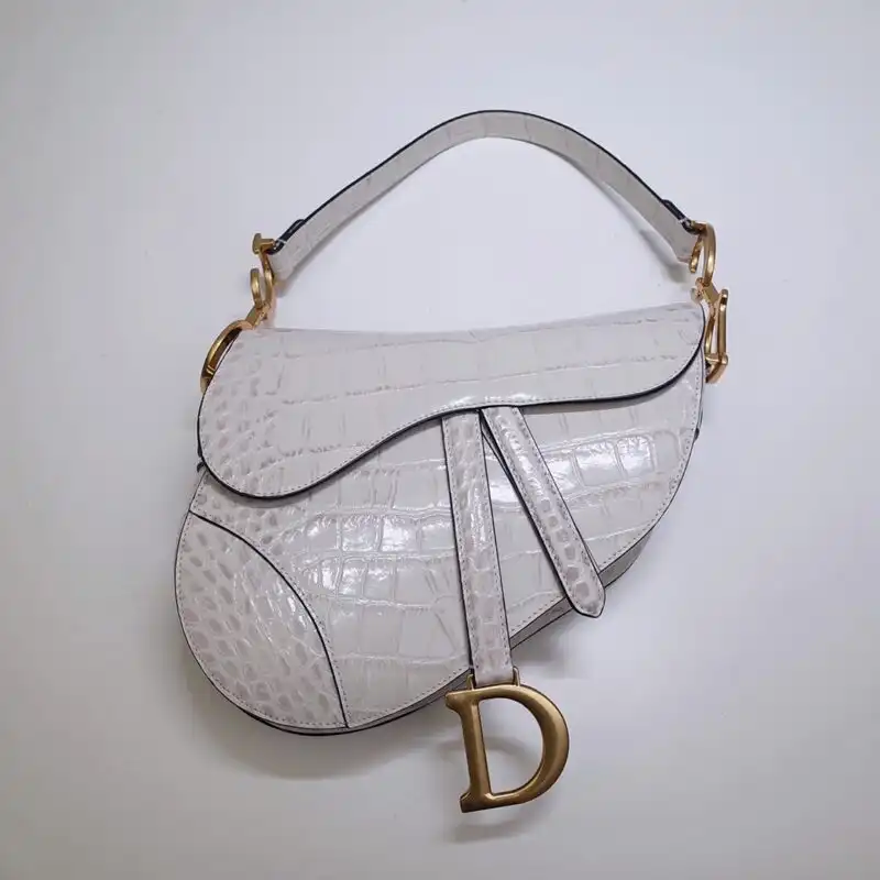 Introducing the exquisite Dior Saddle Bag in luxurious white crocodile leather. Elevate your style with elegance and grace! 👜✨💖 https://tinyurl.com/2crxzvfx