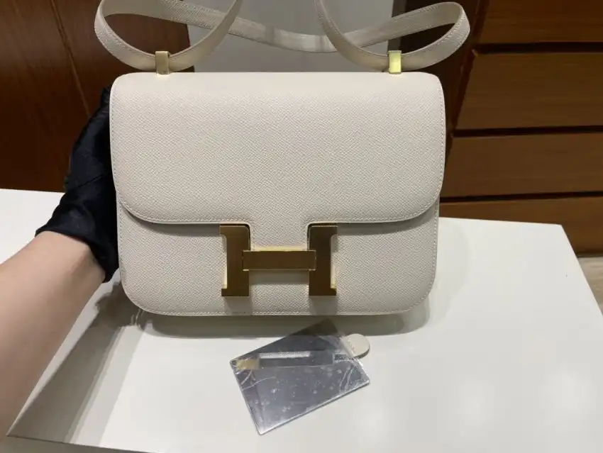 Discover the elegance of the Hermes Constance 24cm in creamy white. A timeless piece that adds a touch of grace to any outfit. 🌼✨👜 https://tinyurl.com/242gecf8