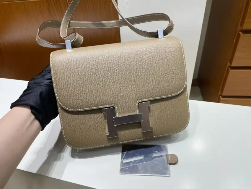 Discover the elegance of the Hermes Constance 24cm in Etoupe. A timeless accessory that brings joy to every moment. 🌟✨👜 https://tinyurl.com/2765jpbu