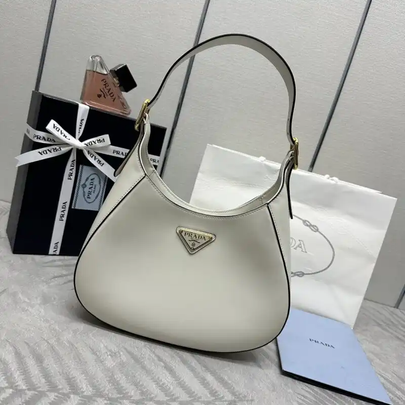 Elevate your style with the Prada Cleo Medium in white. A perfect blend of elegance and charm for every occasion. ✨🤍👜 https://tinyurl.com/287dv47y