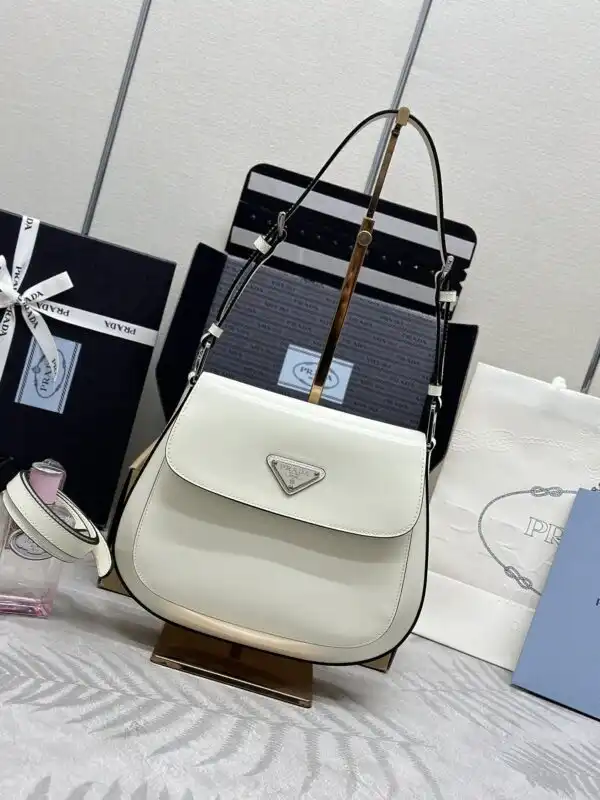 Discover elegance with the Prada Cleo White Bag. Its charming flap design adds a touch of sophistication to any outfit. ✨🤍👜 https://tinyurl.com/2ayxooa2