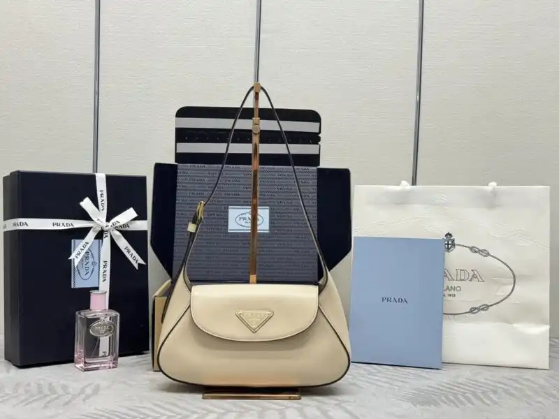 Elevate your style with the Prada Small Shoulder Bag in soft beige. A perfect blend of elegance and charm! 🌟👜✨ https://tinyurl.com/28kekdxs