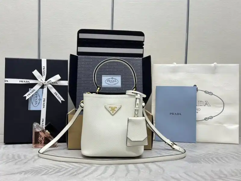 Introducing the timeless elegance of the Prada Saffiano Black Bucket Bag, beautifully accented in white. A perfect companion for any occasion! 🖤🤍✨👜 https://tinyurl.com/2azas3ao