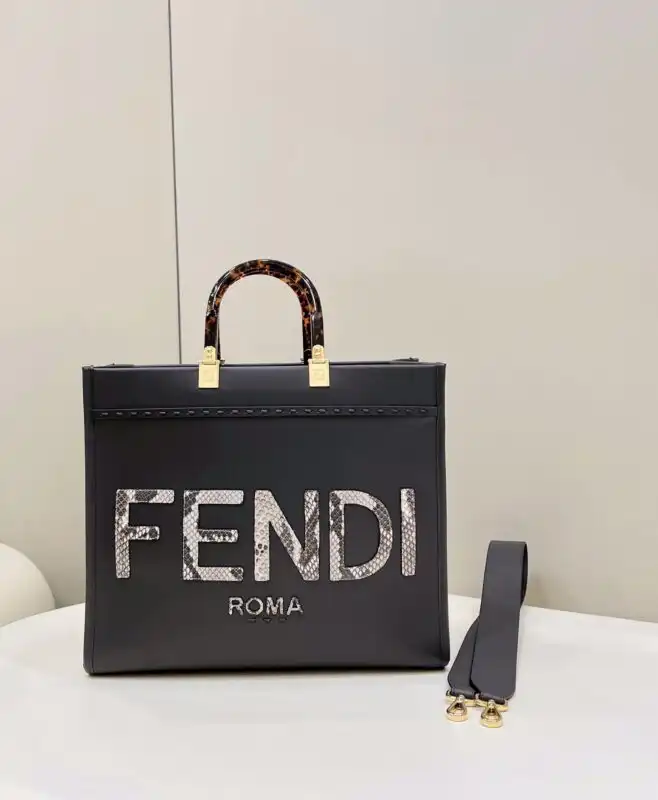 Discover the elegance of the Fendi Sunshine Tote in dark grey. A perfect blend of style and sophistication for every occasion! 🌟👜✨ https://tinyurl.com/25hnfq2f