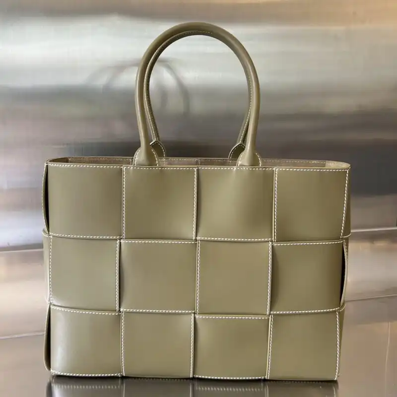 Discover the elegance of the Bottega Veneta Arco Tote in Milk Tea. A perfect blend of style and warmth. 🍂👜✨ https://tinyurl.com/24q9z9cp