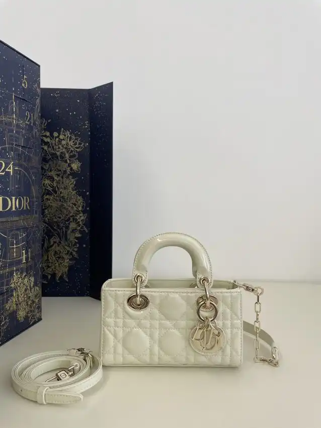 Embrace elegance with the Dior Lady D-Joy Mini Bag in soft white patent. A perfect touch of sophistication for any occasion! ✨💖👜 https://tinyurl.com/2b4h3fz3