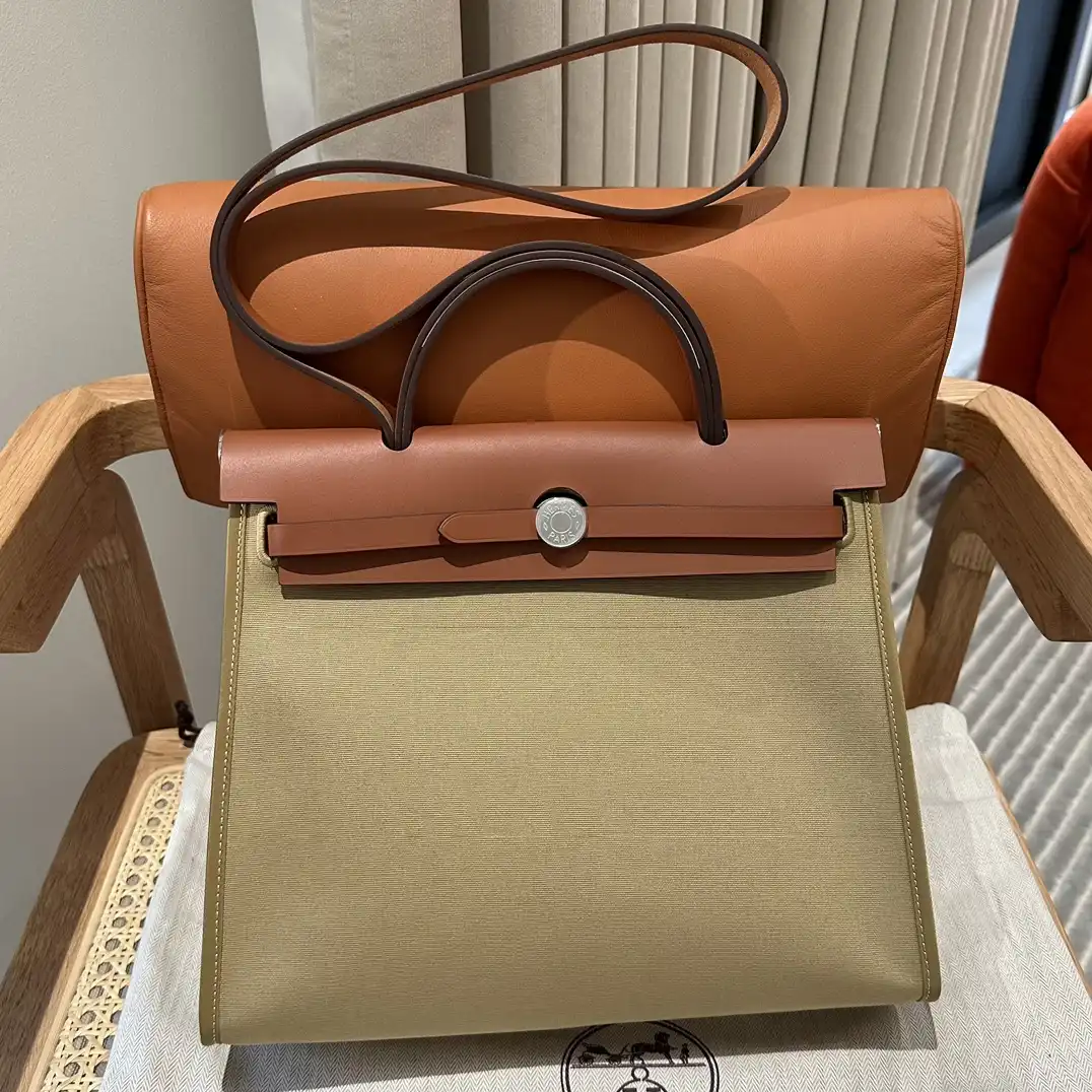 Discover elegance with the Hermes Herbag 31cm in rich brown canvas. A timeless companion for your daily adventures. 👜✨💖 https://tinyurl.com/22e2xeta